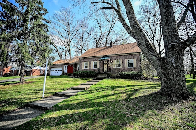 407 N Broadmoor Blvd, Springfield, OH 45504 - single story home featuring an attached garage, a front lawn, brick siding, and a chimney
