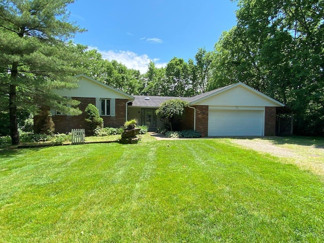 2700 Myeerah Trl, West Liberty, OH 43357 - view of front of house featuring brick siding, driveway, a garage, and a front yard