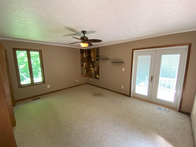 2700 Myeerah Trl, West Liberty, OH 43357 - carpeted spare room featuring ceiling fan, baseboards, ornamental molding, french doors, and a textured ceiling