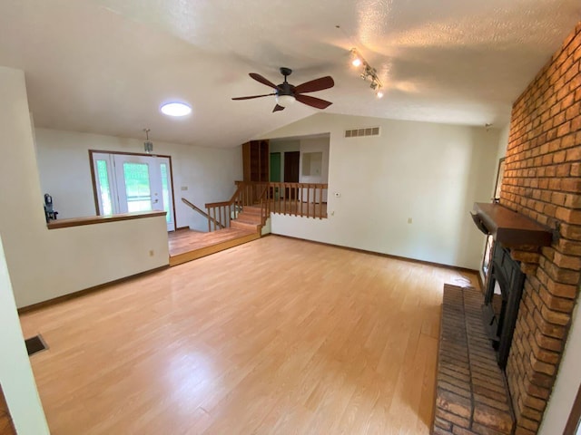 2700 Myeerah Trl, West Liberty, OH 43357 - unfurnished living room with light wood-style flooring, a ceiling fan, vaulted ceiling, and baseboards