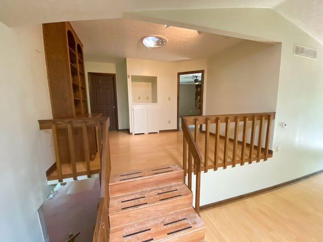 2700 Myeerah Trl, West Liberty, OH 43357 - corridor featuring light wood-style floors, an upstairs landing, vaulted ceiling, and baseboards
