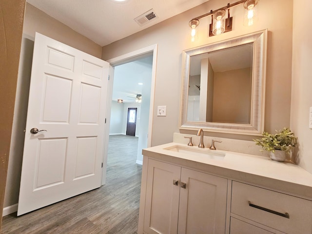 5412 Lock Two Rd, New Bremen, OH 45869 - bathroom featuring ceiling fan, visible vents, wood finished floors, vanity, and baseboards
