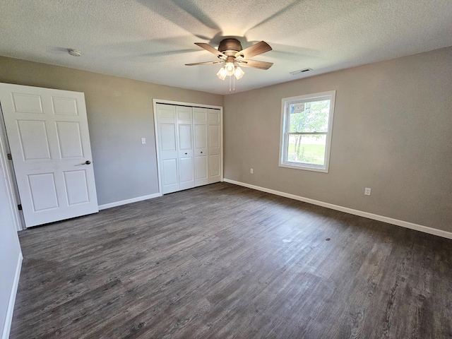 5412 Lock Two Rd, New Bremen, OH 45869 - unfurnished bedroom with a textured ceiling, a ceiling fan, baseboards, dark wood-style floors, and a closet