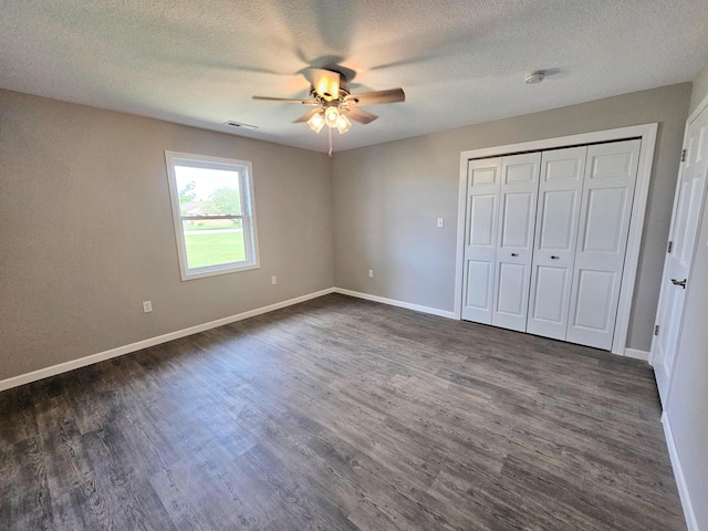 5412 Lock Two Rd, New Bremen, OH 45869 - unfurnished bedroom featuring baseboards, ceiling fan, a textured ceiling, and dark wood-type flooring