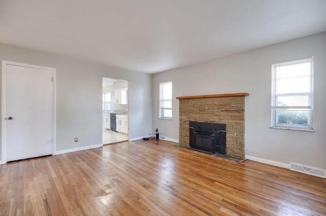 unfurnished living room featuring light wood-type flooring, baseboards, and visible vents