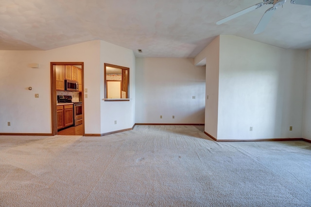 unfurnished living room featuring baseboards, a ceiling fan, and light colored carpet