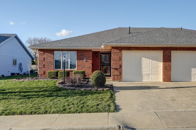ranch-style house featuring a front yard, roof with shingles, concrete driveway, brick siding, and a garage