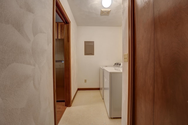 clothes washing area with visible vents, baseboards, laundry area, light floors, and separate washer and dryer