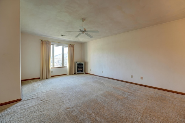 unfurnished living room with light carpet, baseboards, and a ceiling fan