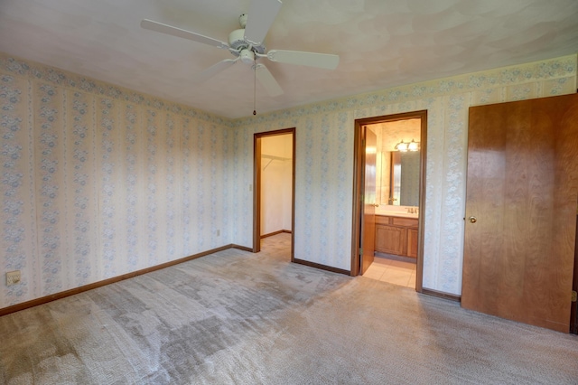 unfurnished bedroom with baseboards, carpet floors, and wallpapered walls