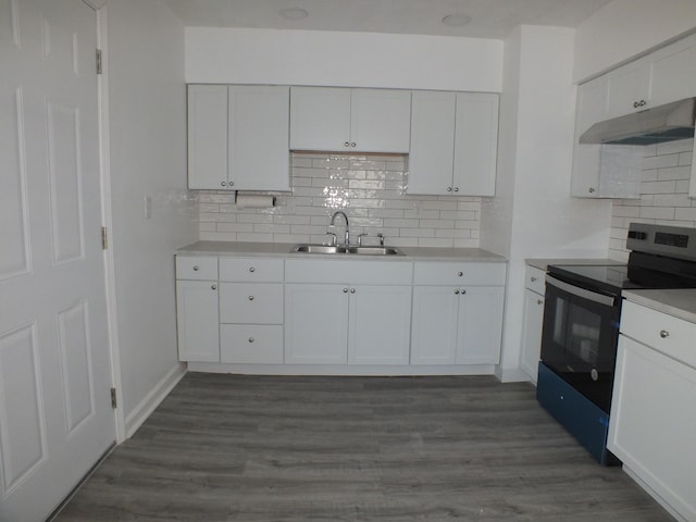 kitchen with white cabinetry, sink, dark hardwood / wood-style floors, and stainless steel range with electric stovetop