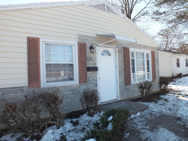 view of snow covered property entrance