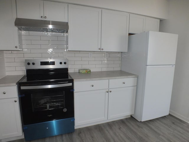 kitchen featuring tasteful backsplash, range with electric cooktop, white cabinets, and white fridge