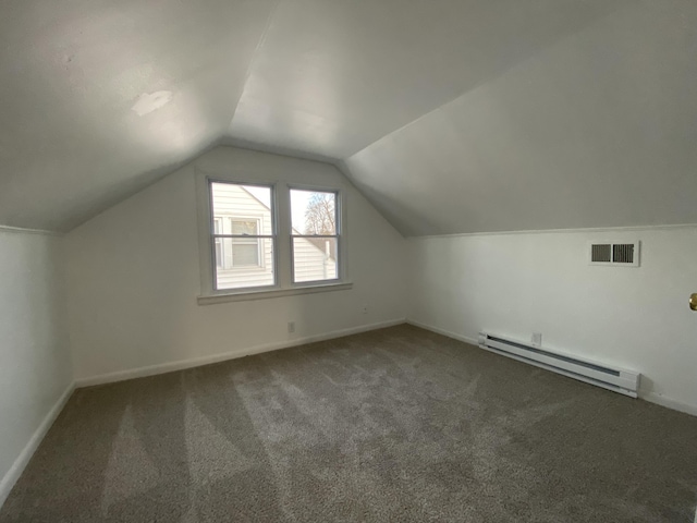 bonus room featuring vaulted ceiling, a baseboard heating unit, and dark carpet