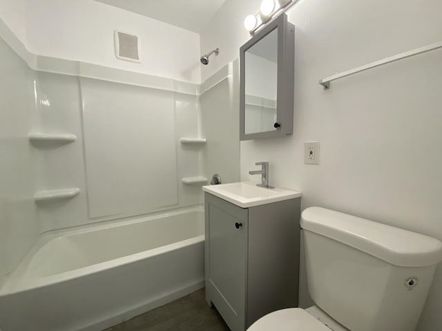 full bathroom with hardwood / wood-style flooring, vanity, toilet, and tub / shower combination