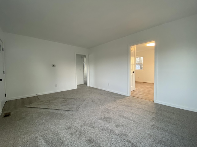 unfurnished room with light colored carpet