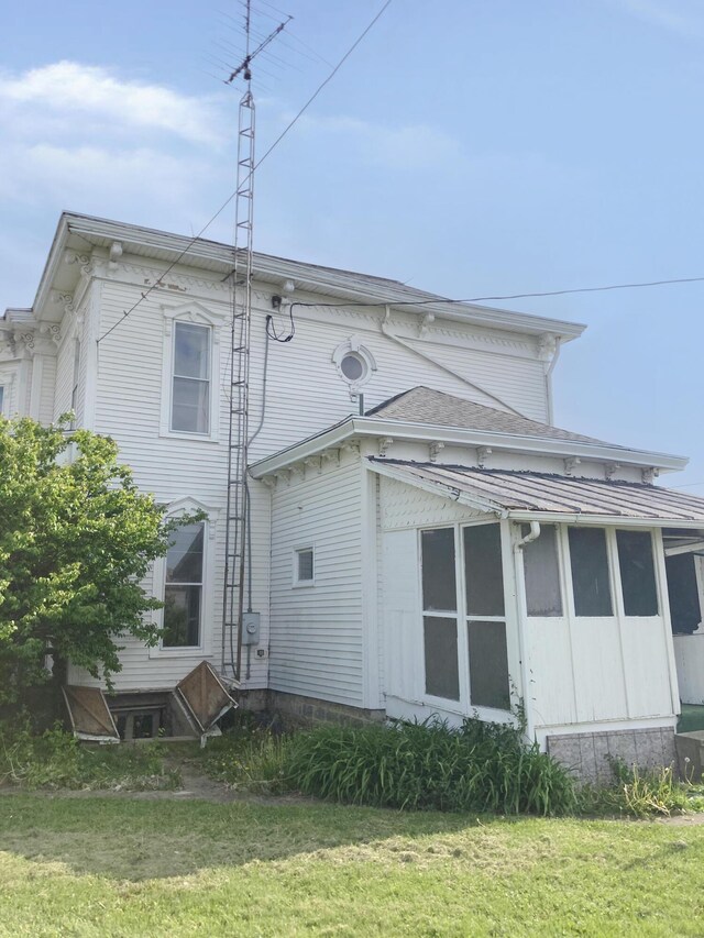 119 E Orchard St, West Manchester, OH 45382 - back of house featuring a sunroom and a lawn