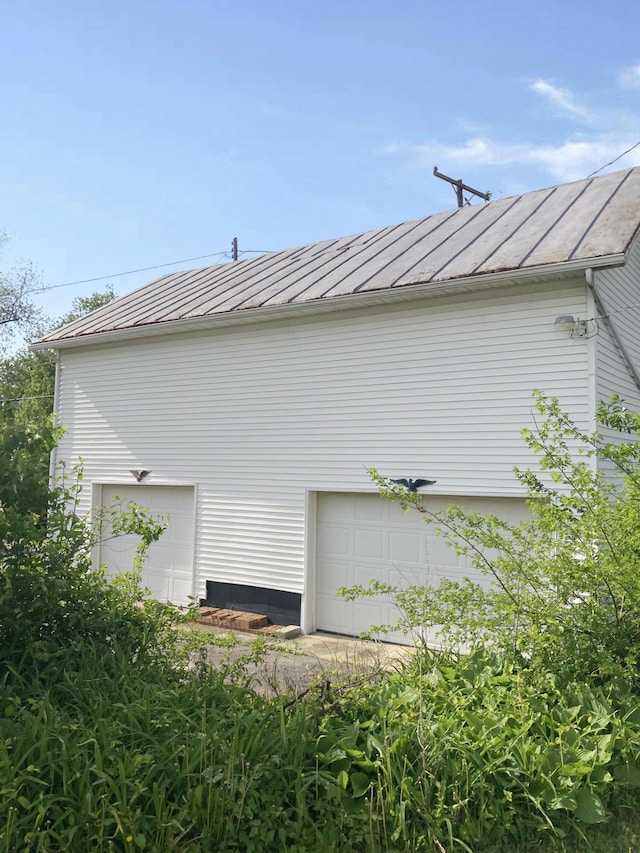119 E Orchard St, West Manchester, OH 45382 - view of home's exterior with metal roof and a garage