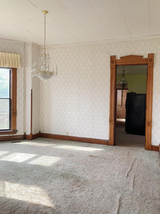 119 E Orchard St, West Manchester, OH 45382 - spare room with carpet floors, a chandelier, wallpapered walls, and baseboards