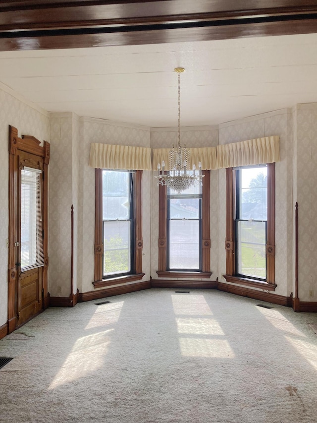 119 E Orchard St, West Manchester, OH 45382 - unfurnished dining area featuring carpet flooring, a chandelier, plenty of natural light, wallpapered walls, and crown molding