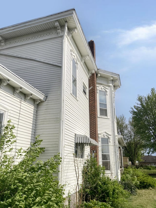 119 E Orchard St, West Manchester, OH 45382 - view of side of property with a chimney