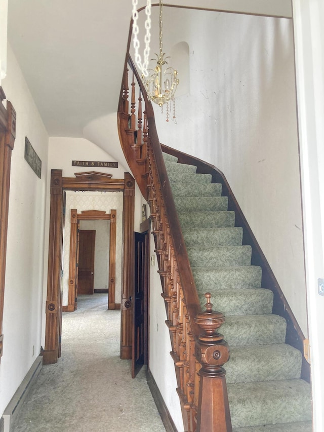 119 E Orchard St, West Manchester, OH 45382 - staircase with a chandelier and carpet