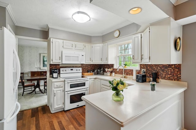 7657 Winding Way N, Tipp City, OH 45371 - kitchen with a sink, white appliances, white cabinetry, a peninsula, and light countertops