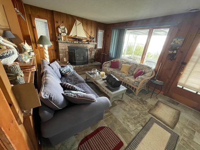 living room with stone finish floor and wooden walls