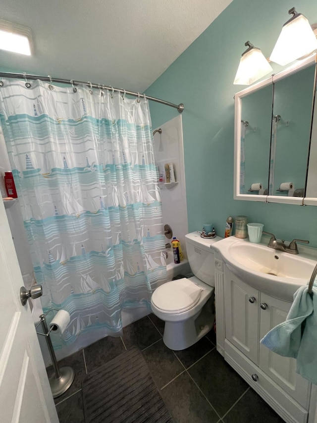 bathroom featuring toilet, shower / bath combo, vanity, and tile patterned floors