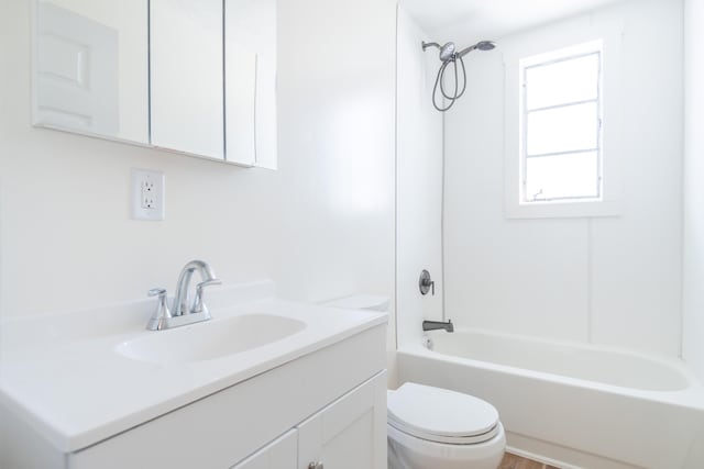 bathroom with toilet, tub / shower combination, and vanity