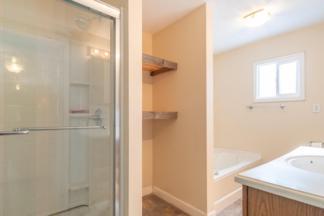 bathroom with baseboards, a shower stall, vanity, and a bath