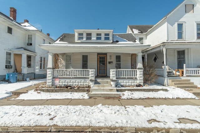 view of front of home featuring covered porch and cooling unit