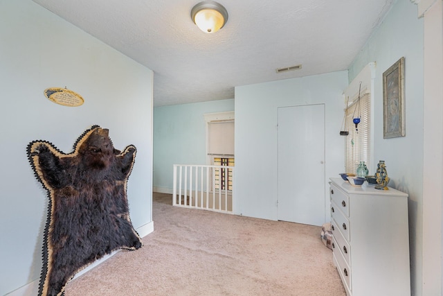 815 Mckaig Ave, Troy, OH 45373 - corridor with carpet floors, a textured ceiling, and an upstairs landing