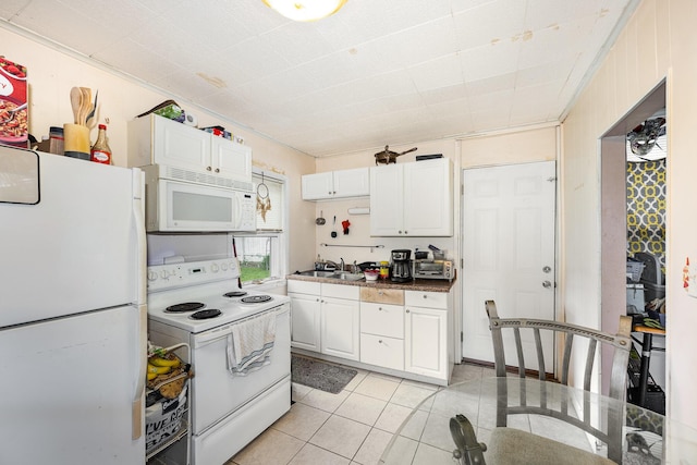 815 Mckaig Ave, Troy, OH 45373 - kitchen with white appliances, white cabinets, light tile patterned floors, and dark countertops