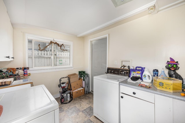 815 Mckaig Ave, Troy, OH 45373 - laundry area with washer and clothes dryer, stone finish floors, and cabinet space