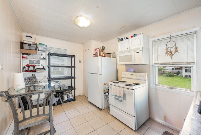 815 Mckaig Ave, Troy, OH 45373 - kitchen with white appliances, light tile patterned floors, and white cabinetry