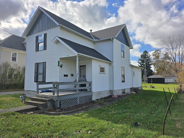 rear view of property with a lawn and a deck