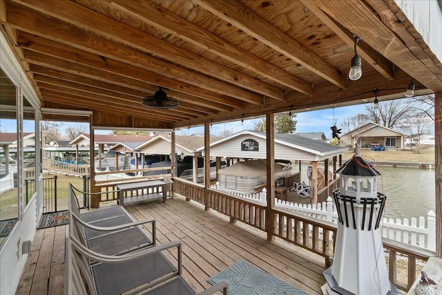 deck with a dock, boat lift, and a residential view