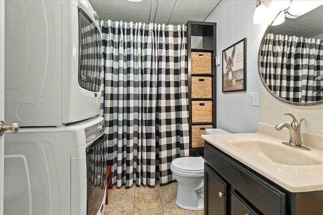 bathroom featuring stacked washer and dryer, a shower with curtain, vanity, and toilet