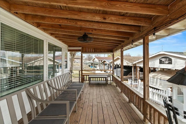 wooden terrace with a boat dock and ceiling fan