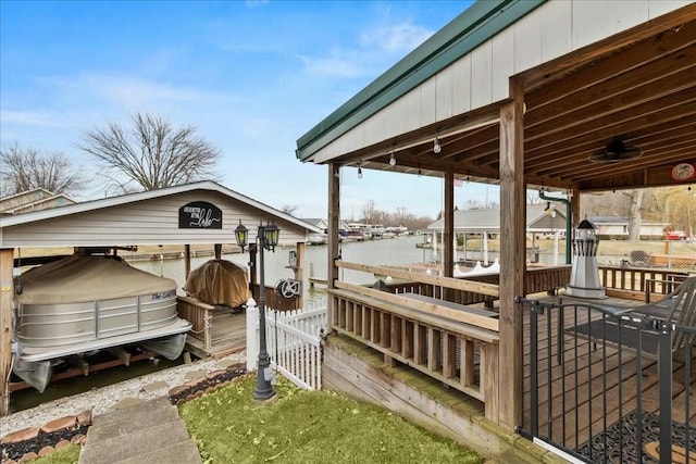 wooden deck with a boat dock and boat lift