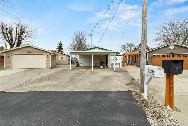 view of front of property featuring a garage and an outbuilding