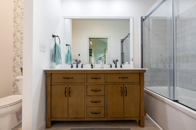 6565 Windjammer Dr, Huntsville, OH 43324 - full bath with double vanity, combined bath / shower with glass door, toilet, and tile patterned flooring