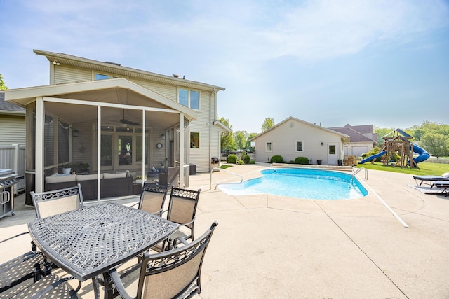 6565 Windjammer Dr, Huntsville, OH 43324 - view of swimming pool featuring a patio area, a sunroom, a ceiling fan, a playground, and outdoor dining space