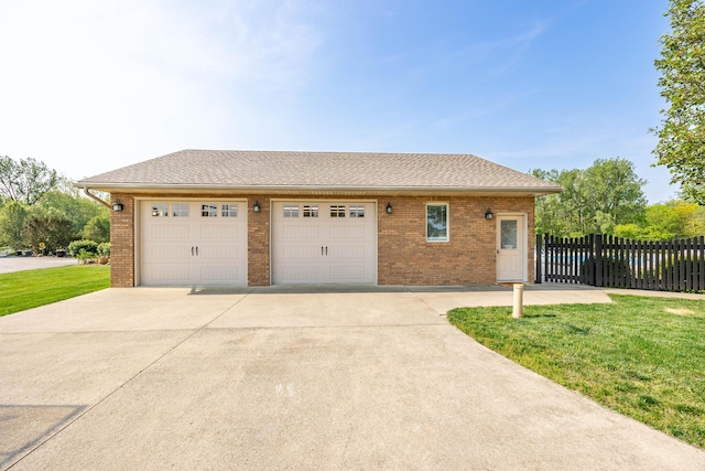 6565 Windjammer Dr, Huntsville, OH 43324 - view of front of house featuring a garage, brick siding, and driveway