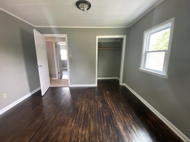 823 Robinson Ave, Piqua, OH 45356 - unfurnished bedroom with ornamental molding, hardwood / wood-style floors, baseboards, and a closet