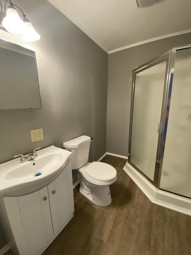 823 Robinson Ave, Piqua, OH 45356 - bathroom featuring wood finished floors, a stall shower, vanity, ornamental molding, and toilet