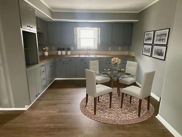 823 Robinson Ave, Piqua, OH 45356 - kitchen featuring a sink, crown molding, dark wood finished floors, and baseboards