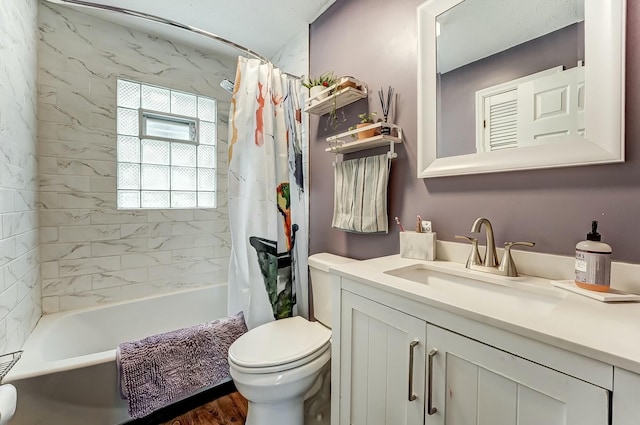 bathroom featuring shower / bath combo with shower curtain, toilet, and vanity