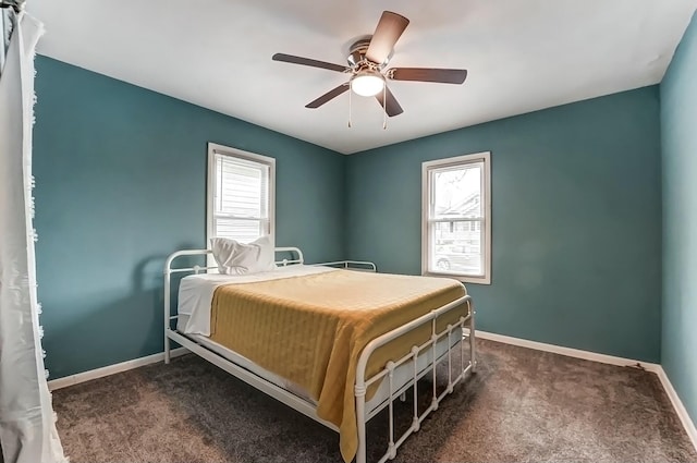 bedroom featuring a ceiling fan, baseboards, and dark carpet